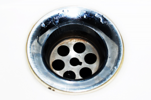 Close up of drain in white sink