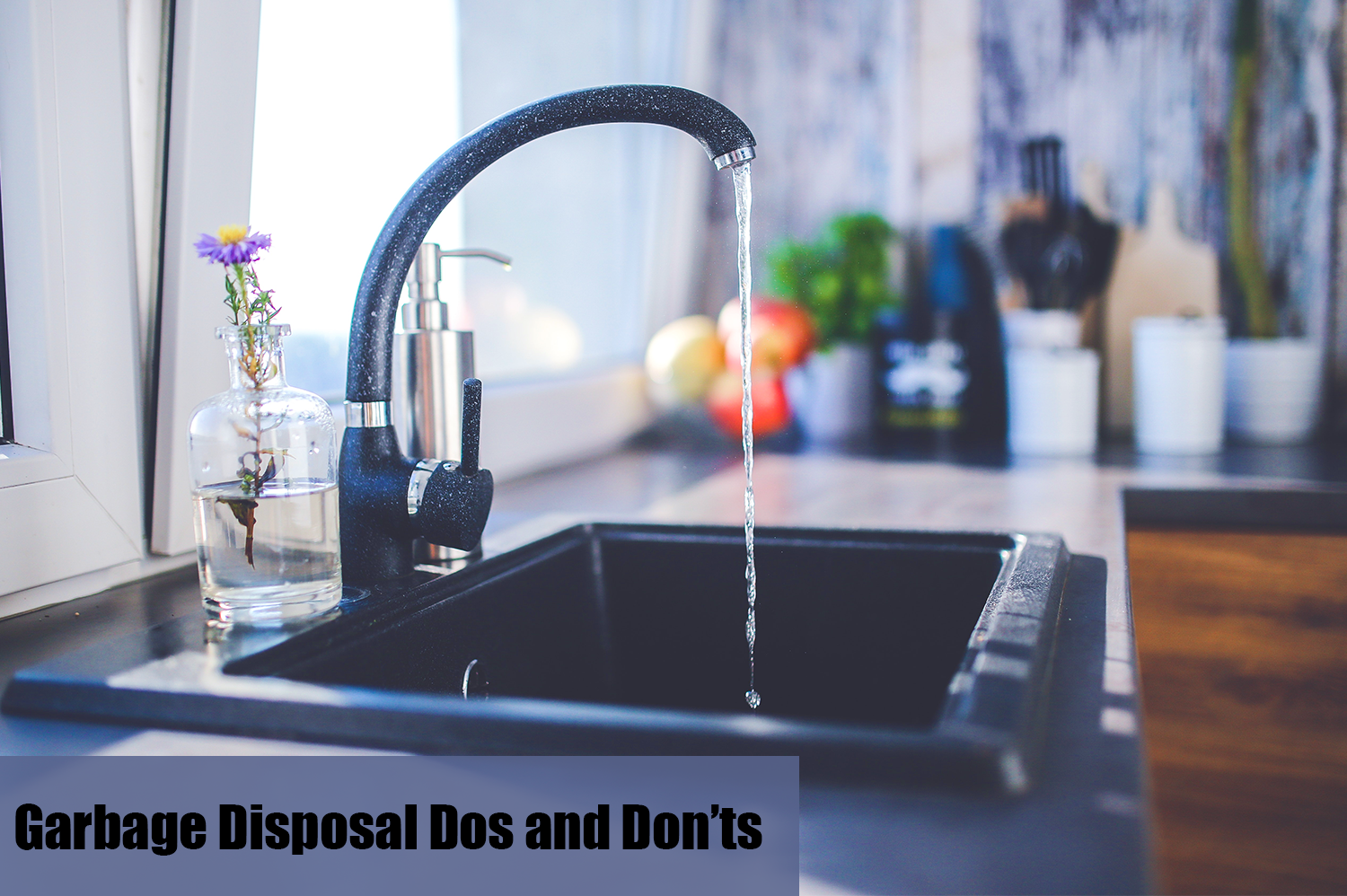 Black kitchen sink running water into garbage disposal.