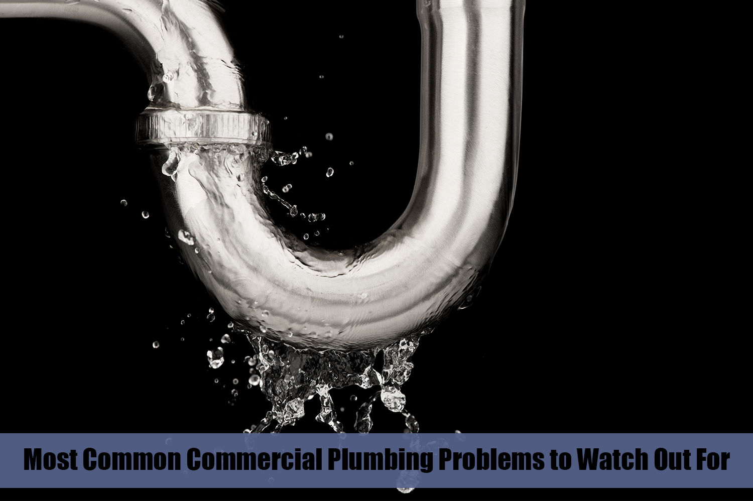A leaking pipe with a black background; one of the most common commercial plumbing problems.